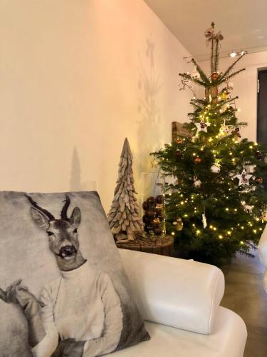 a christmas tree and a pillow with a picture of a deer at ARVAK HEYD (DURBUY) in Heyd