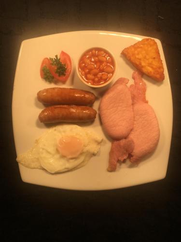 a plate of breakfast food with eggs sausage beans and toast at "The County" in Selkirk