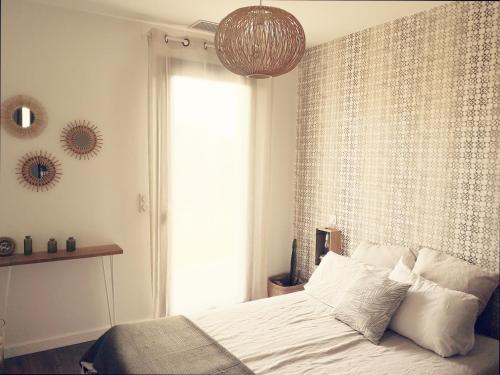 Chez Jo chambre d'hôtes في Montastruc-la-Conseillère: غرفة نوم بسرير ونافذة كبيرة