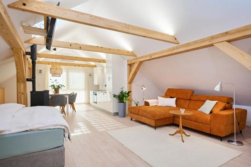 a bedroom with a bed and a couch and a table at Apartment P42 in Slovenj Gradec