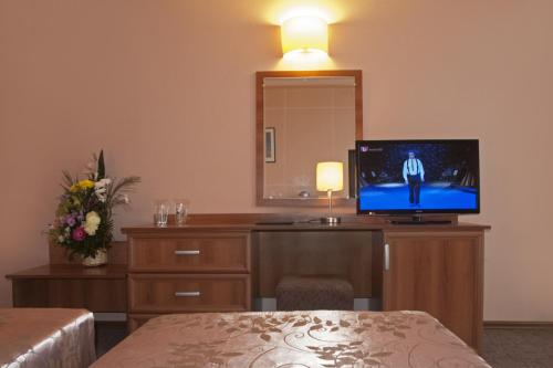 a hotel room with a television on a desk at Hotel Real in Plovdiv