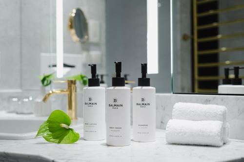 three bottles ofodorizers sitting on a bathroom counter at Sofitel Warsaw Victoria in Warsaw