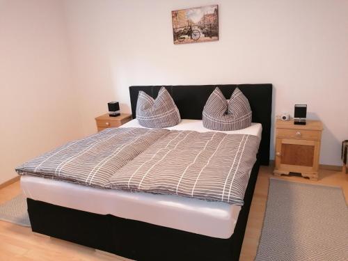 a bedroom with a large bed with two night stands at Ferienwohnung DORO in Kelberg