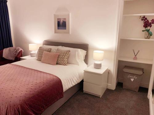 a bedroom with a bed with two lamps on it at No's 7 and 8 Llewelyn Apartments in Llanberis