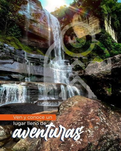 a poster of a waterfall with the words very at La Cabaña Eco Hotel in Suaita