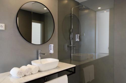 a bathroom with a sink and a mirror at Marinhas Bed & Breakfast in Esposende