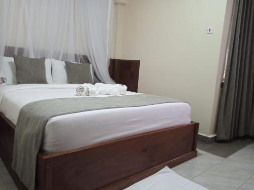 Postel nebo postele na pokoji v ubytování Logmma Regency Hotel