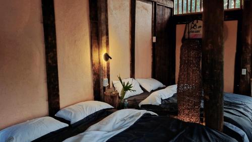 a group of three bunk beds in a room at Mô he in Sơn Tây