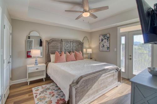 a bedroom with a bed with pink pillows and a ceiling fan at Fantastic Location! River and Mountain Views 2BR/2BA Sleeps 6 in Pigeon Forge
