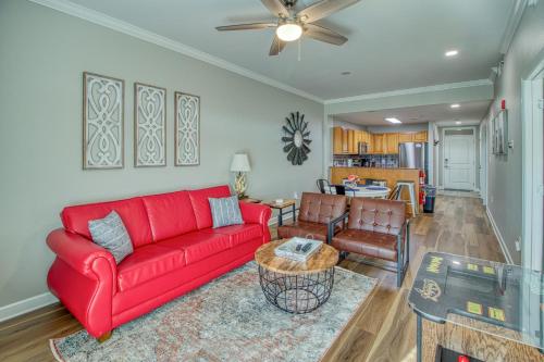 a living room with a red couch and a table at Fantastic Location! River and Mountain Views 2BR/2BA Sleeps 6 in Pigeon Forge