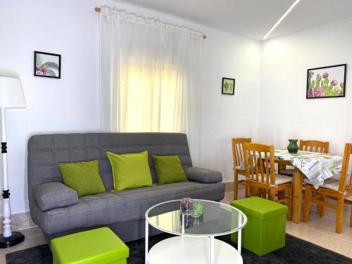 a living room with a couch and a table at Casa el Tejar - Apartamento céntrico y acogedor in Arcos de Jalón
