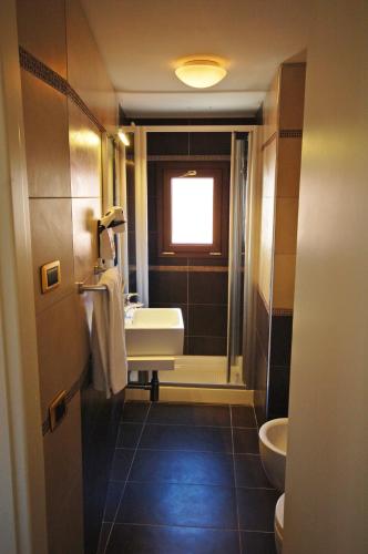 a bathroom with a sink and a toilet at Hotel Torino in Venice
