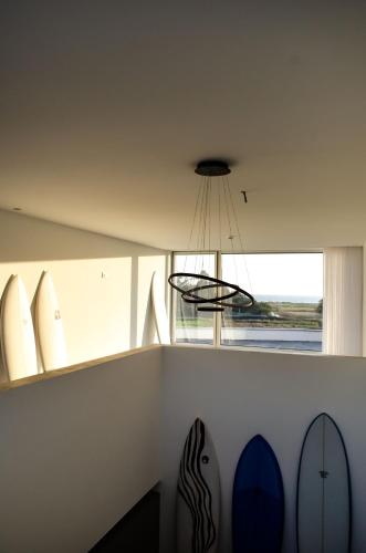a room with surfboards on a wall next to a window at Marinhas Bed & Breakfast in Esposende