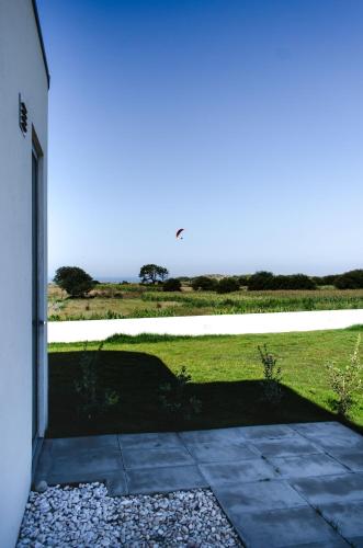 a door to a building with a view of a field at Marinhas Bed & Breakfast in Esposende