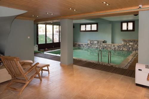 a large indoor pool with a table and a chair at Alpine Aria in Kalavrita
