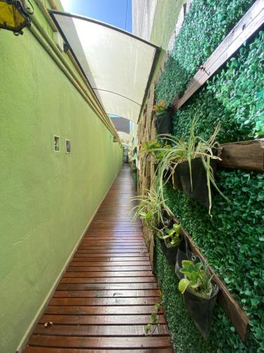 a walkway with plants on the side of a building at Garden Loft in Rosario