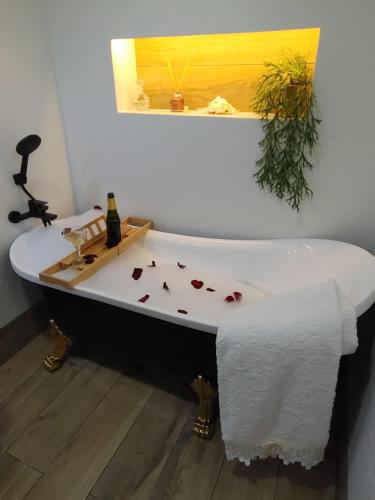 a bath tub with a bottle of wine on it at Quinta das Águias in Aveiro