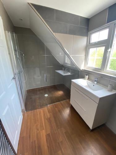 a bathroom with a sink and a shower at 37 The Street, Weeley, Clacton on Sea, Essex CO16 9JD in Weeley