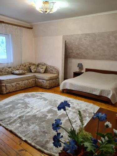 un soggiorno con letto e divano di Lara a Solochyn