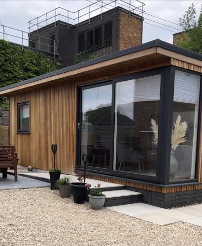 a house with large glass windows on the side of it at Segais Accommodation in Grove