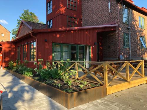 a red building with a wooden fence in front of it at Kvibergs Vandrarhem - Hostel in Gothenburg