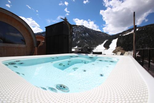 a jacuzzi tub sitting on top of a building at Hotel Mirabel in San Vigilio Di Marebbe