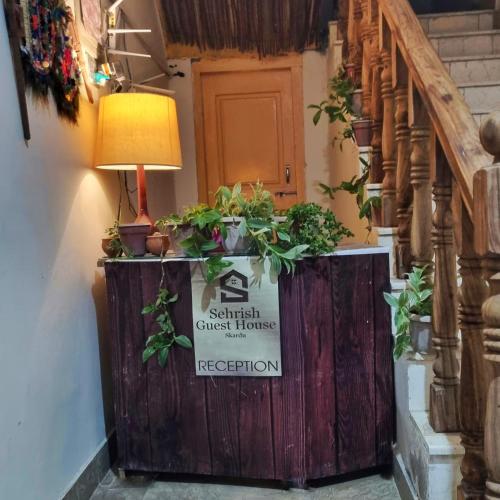 a staircase with a sign that reads guerrilla guest house at Sehrish Guest House Skardu in Skardu
