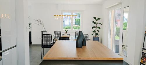 a dining room with a wooden table and chairs at Cocoon Bed and Breakfast in Fegersheim