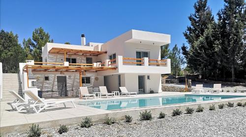 a villa with a swimming pool and a house at Chrysanthi Villa, Living in Nature in vlicha