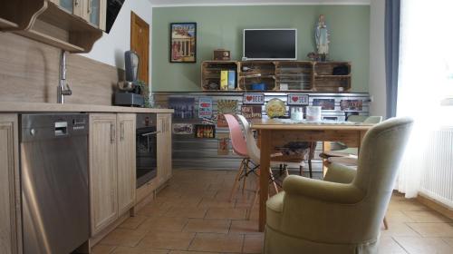 a kitchen with a table and chairs and a television at Fantazja Góra Św Anny in Góra Świętej Anny