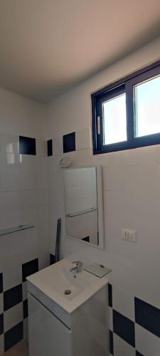 a bathroom with a sink and a mirror at Penthouse with Terrace in Santa Maria Ca Firenze Sal Service in Santa Maria