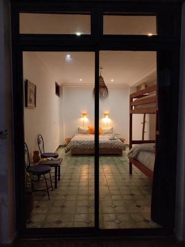 a bedroom with a bed and a sliding glass door at Imsouane Surf Paradise in Imsouane