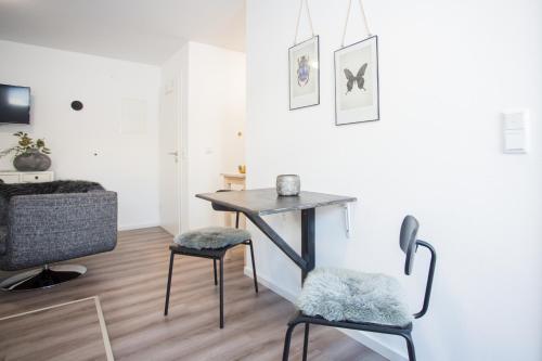 a dining room with a table and two chairs at NaturLiebe in Winterberg