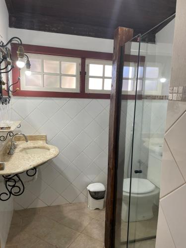 a bathroom with a sink and a toilet at POUSADA PARLATORIUM in Tiradentes