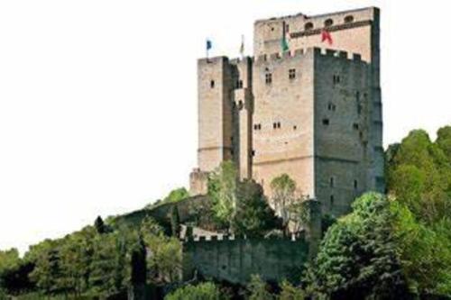 a large castle on top of a hill with trees at Christophe in Crest