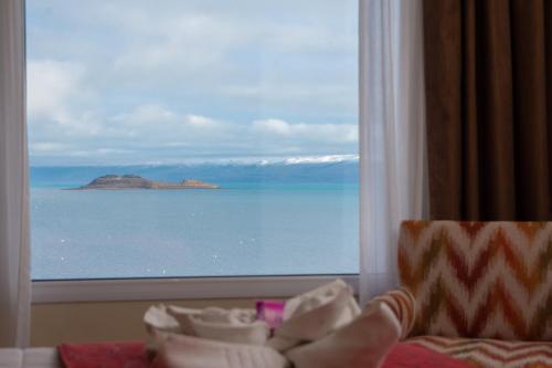 a view of the ocean from a hotel room window at Hotel Las Dunas in El Calafate