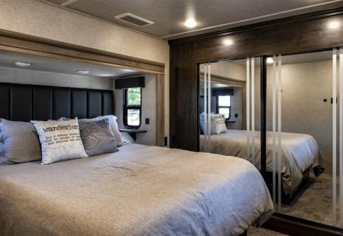 a bedroom with a large bed and a mirror at H - Driftwood in Fort Bragg
