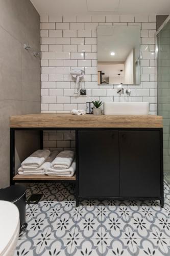 a bathroom with a counter with a sink and a mirror at Ethereal Athεns in Athens