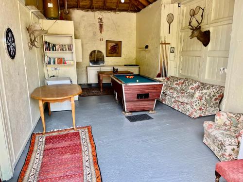 a living room with a pool table in it at Cozy Cottage. Close to beach & woodland walks in Colinsburgh