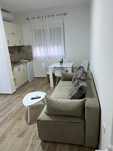 a living room with a couch and a table at Relax Apartmani in Sutomore