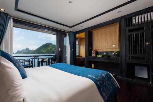 a bedroom with a bed and a view of the water at La Regina Grand Cruise in Ha Long
