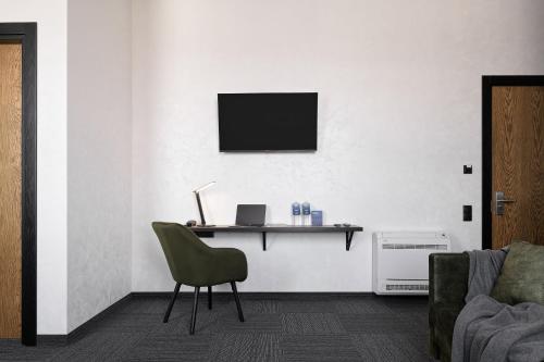 a room with a desk with a laptop and a chair at Ribas Rooms Bila Tserkva in Bila Tserkva