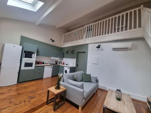 un salon avec un canapé et une cuisine dans l'établissement La Marceline 1 - Appart entre mer et canal du midi en pays Cathare, à Saint-Marcel