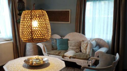 a living room with a couch and a table at B&B de Valkenhorst in Lelystad