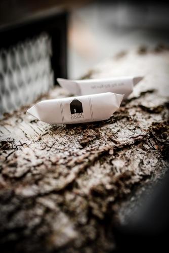 a white remote control sitting on top of a table at Czarne Domki in Zwierzyniec