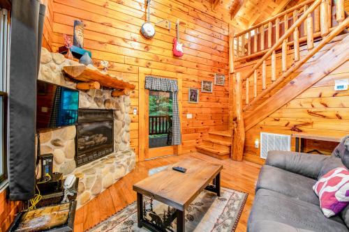 a living room with a couch and a fireplace at Sweet Fantasy in Sevierville