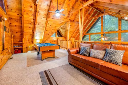 a living room with a couch and a pool table at Sweet Fantasy in Sevierville