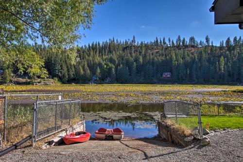 three canoes sitting on the shore of a lake at A Contemporary Dream Lakefront Rathdrum Oasis! in Rathdrum