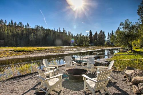 a group of chairs sitting next to a pond at A Contemporary Dream Lakefront Rathdrum Oasis! in Rathdrum