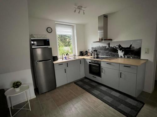 a kitchen with a stainless steel refrigerator and a sink at 2 Exklusive Ferienwohnungen an der Nordsee in Bremerhaven